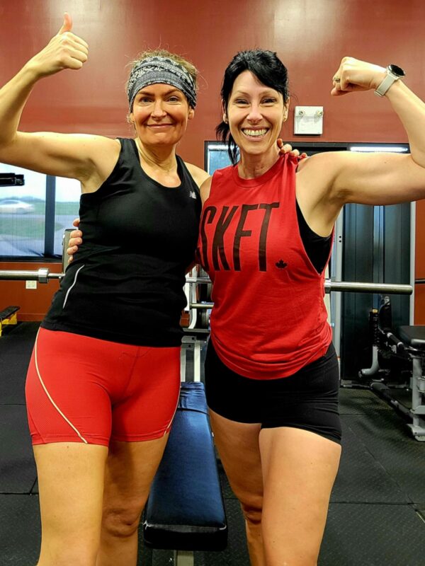 Two women flexing